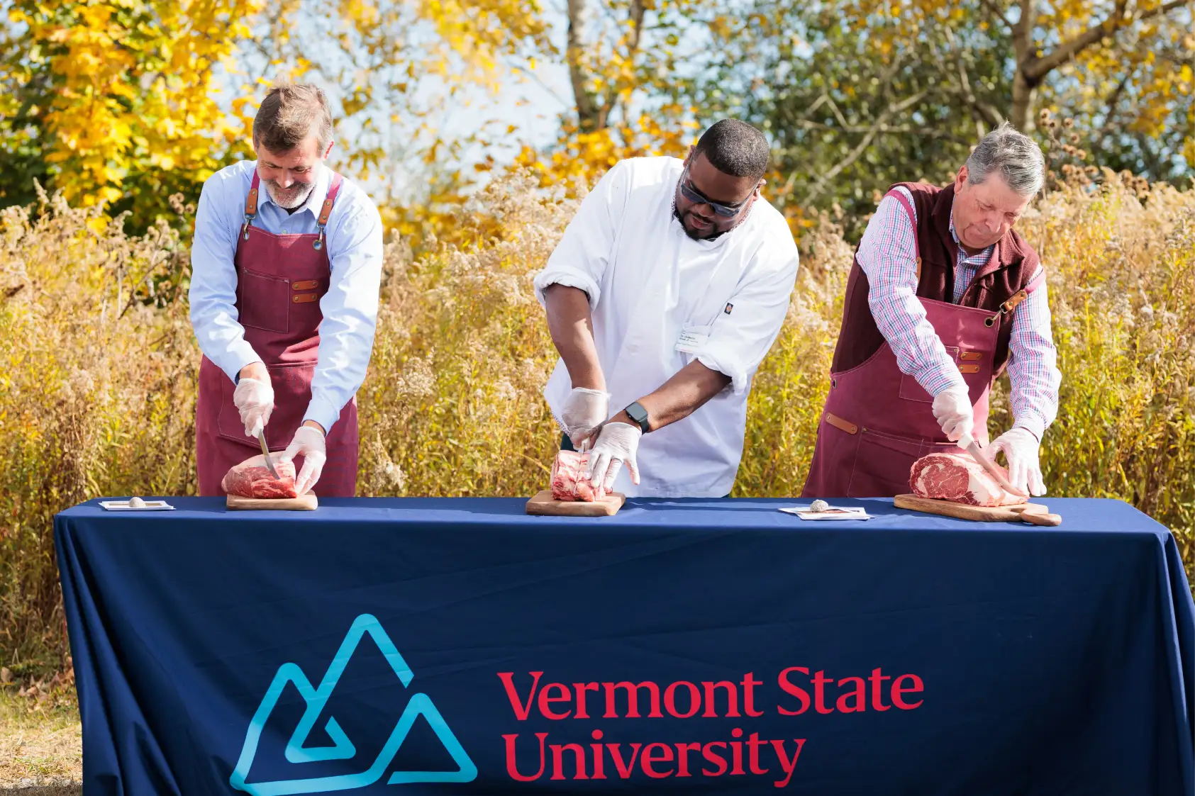 Three men cutting ribeye steaks at VTSU Randolph