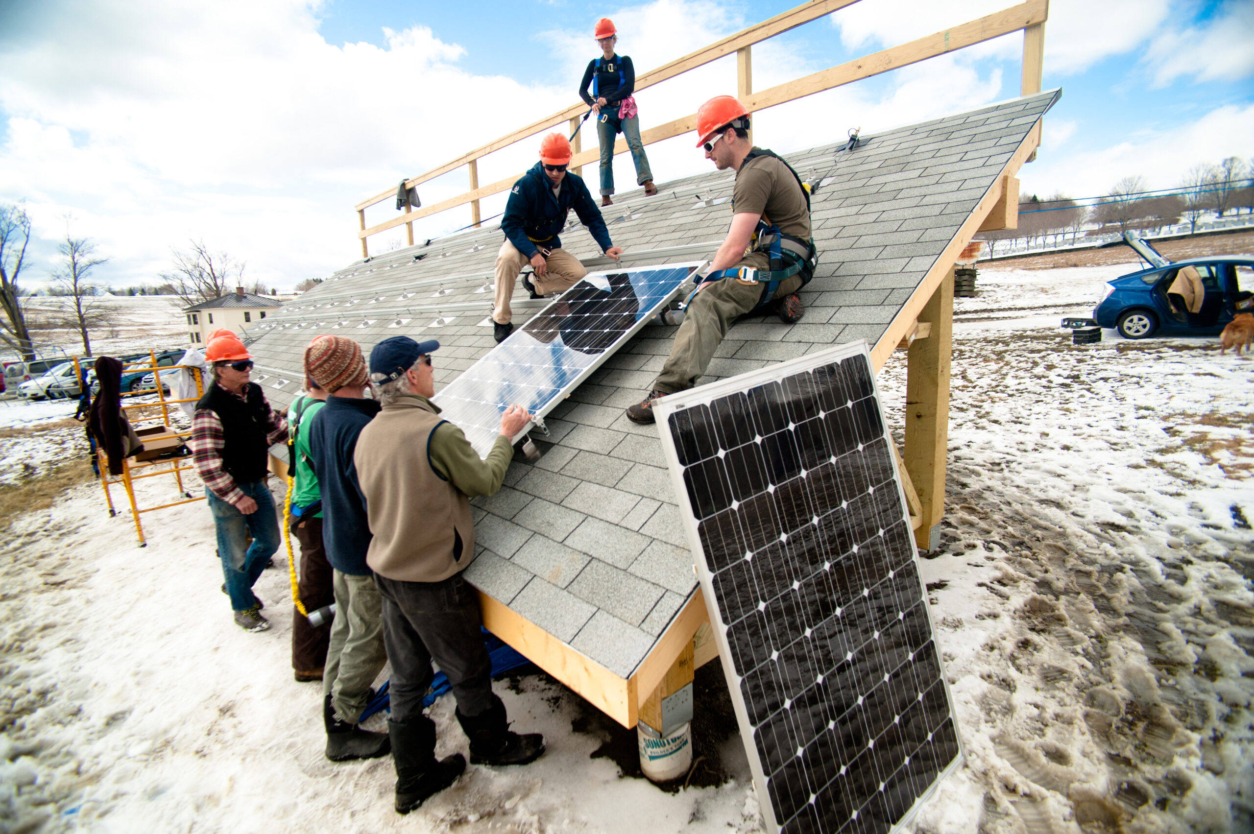 A group of students working to install solar panels.