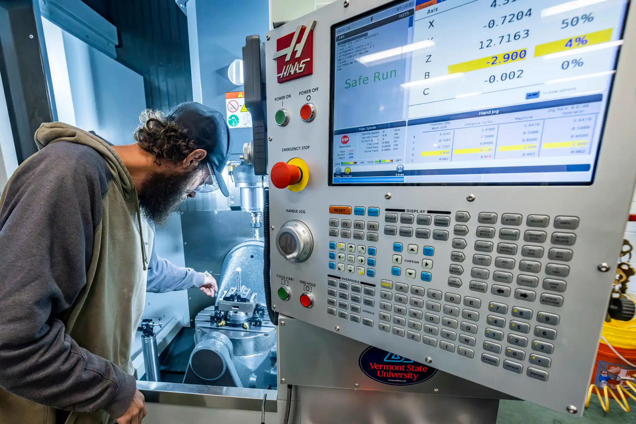 A man working with machining equipment